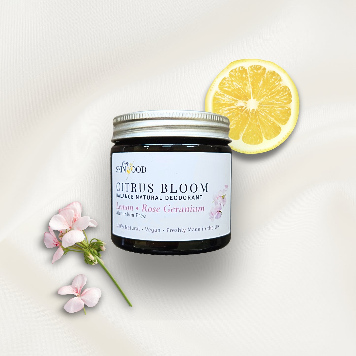 Jar of My Skinfood Citrus Bloom natural aluminium free deodorant with a lemon slice and geranium on a light background