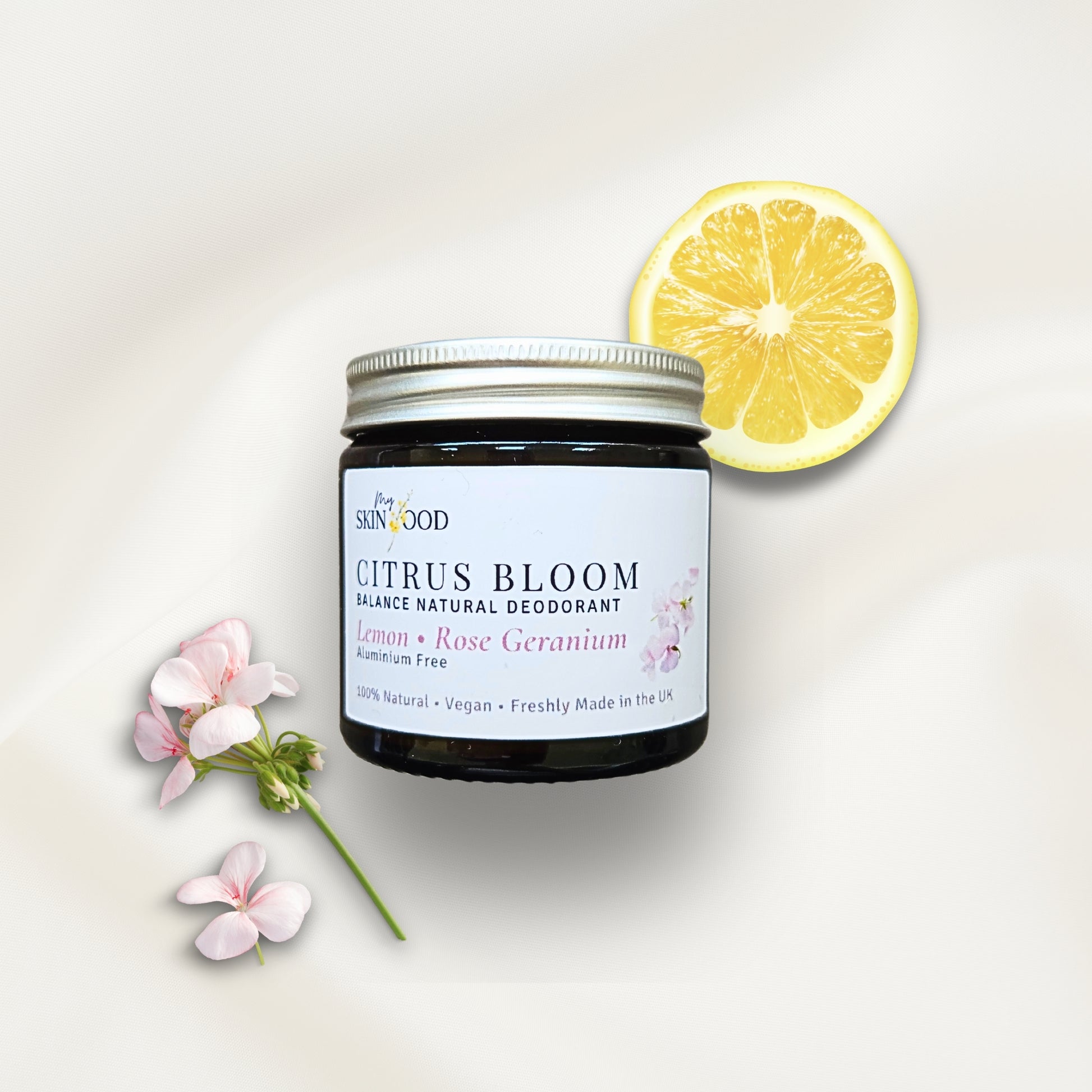 Jar of My Skinfood Citrus Bloom natural aluminium free deodorant with a lemon slice and geranium on a light background