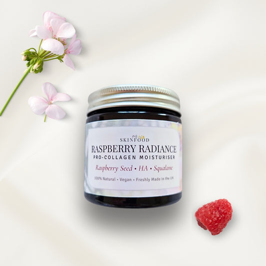 Jar of My Skinfood raspberry radiance moisturizer with flowers and a raspberry on a light background