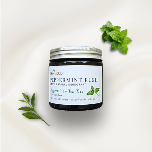 Jar of My Skinfood peppermint rush natural aluminium free deodorant with mint and tea tree leaves on a light background