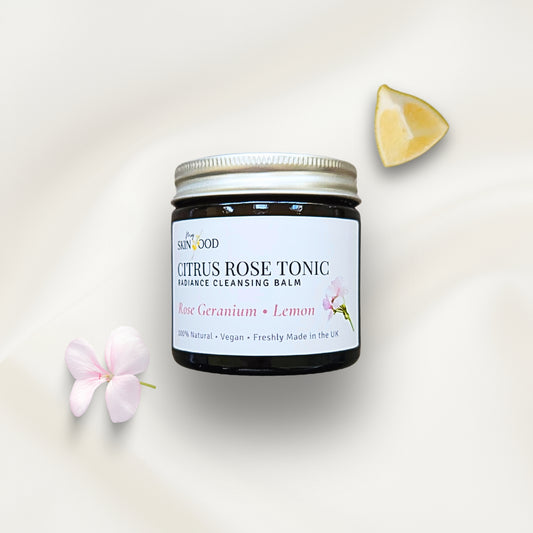 Jar of My Skinfood Citrus Rose Tonic Cleansing Balm with a lemon wedge and geranium flower on a light background