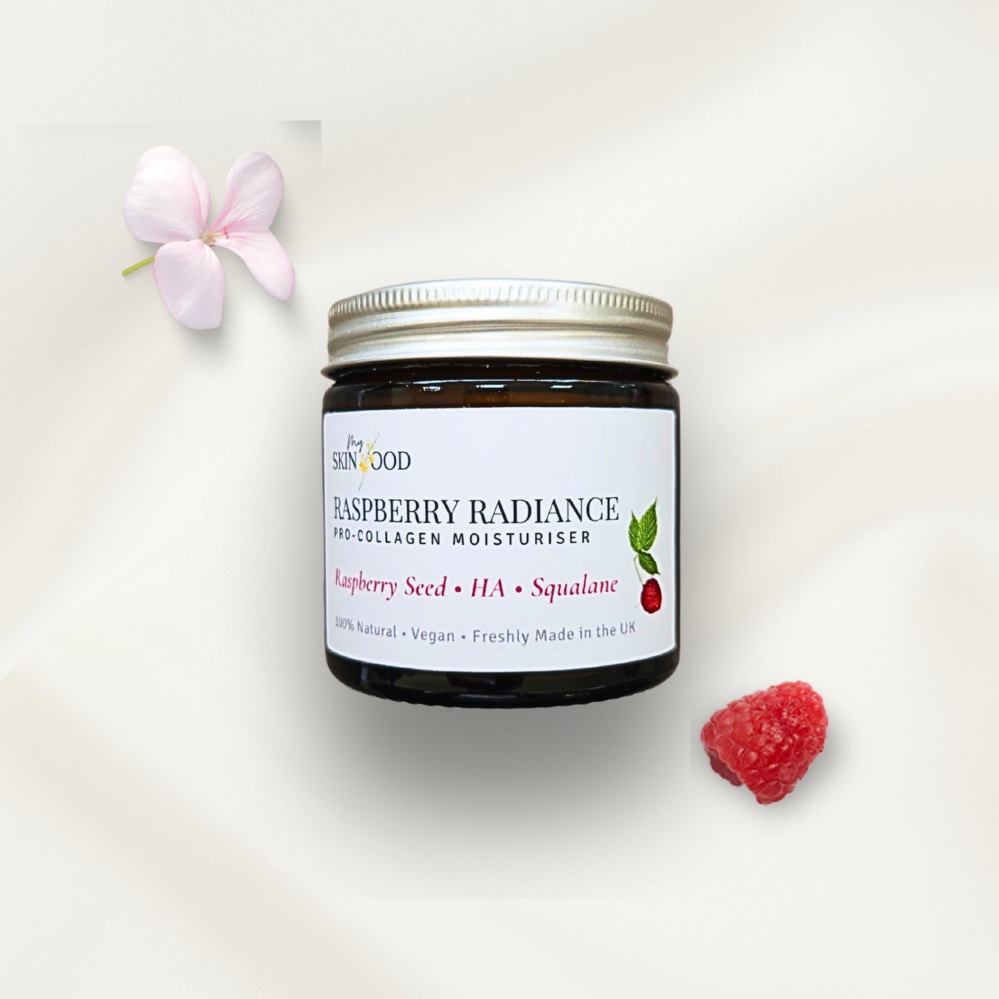 Jar of My Skinfood raspberry radiance mineral natural SPF moisturizer with a raspberry seed oil and flower on a white background