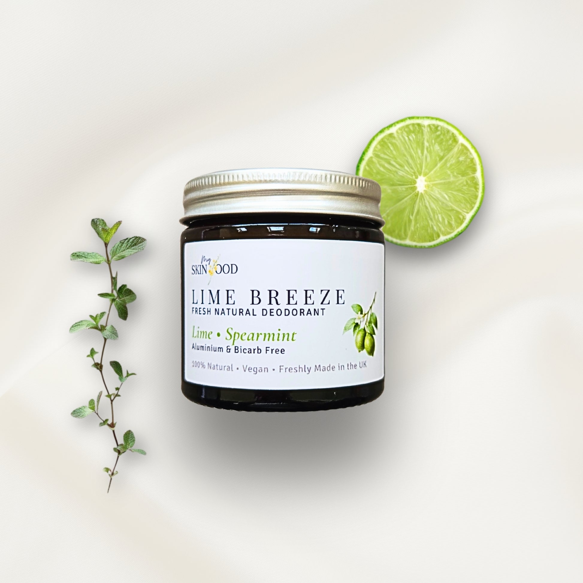 Jar of My Skinfood Lime Breeze natural aluminium free deodorant with a lime and mint leaves on a light background