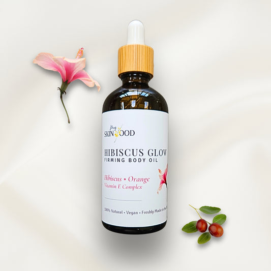 Bottle of My Skinfood Hibiscus Glow Firming Body Oil with a pink flower and green leaves on a light background